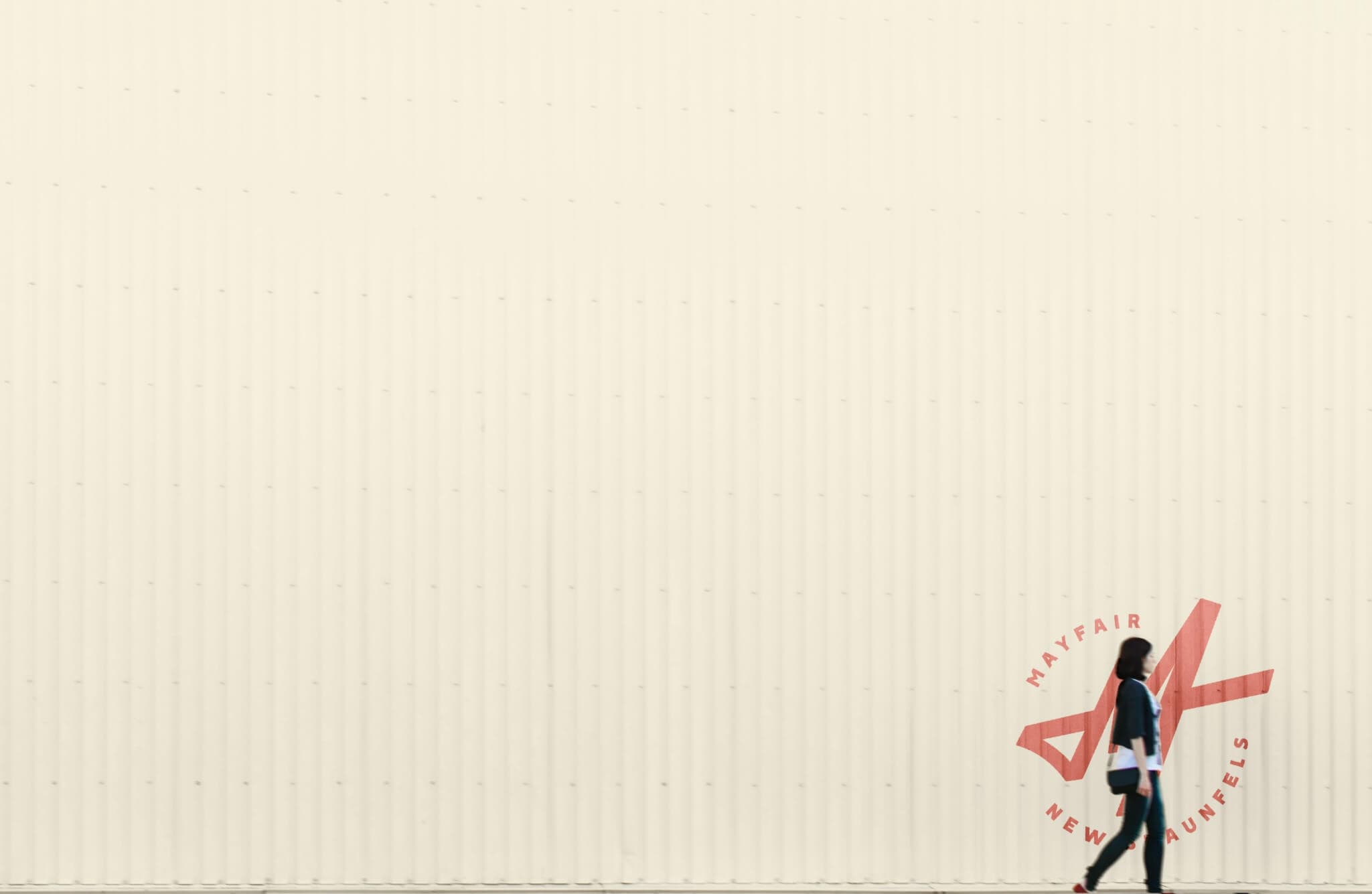 A woman strolling near new homes in New Braunfels.