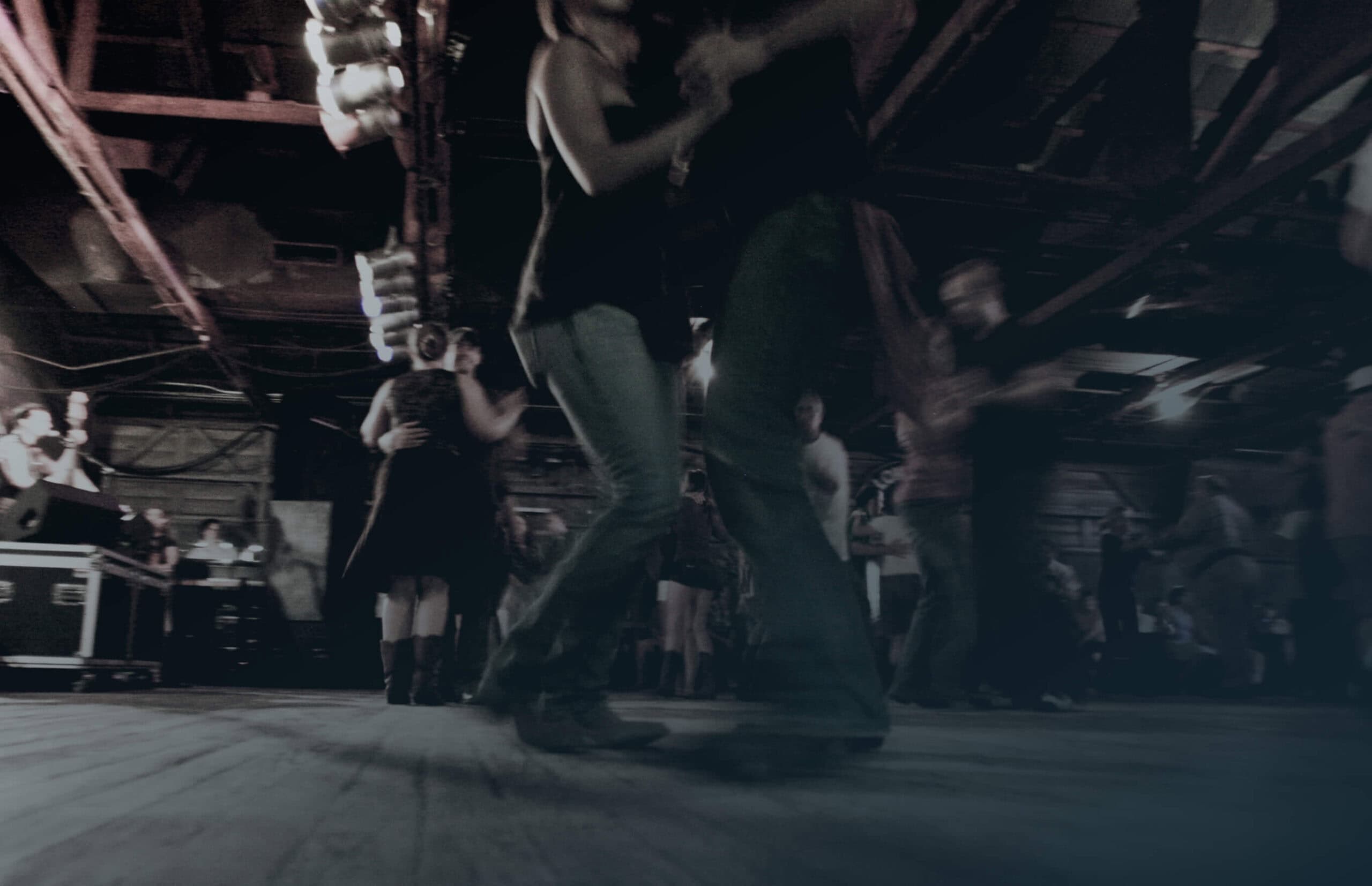 A couple dancing in a dimly lit room.